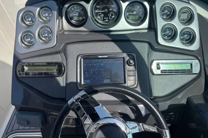 Slide: The Image of Dashboard of a 2014 Monterey 328SS Super Sport boat with gauges and navigation system. - 28