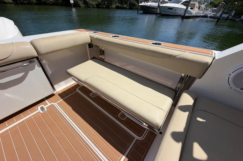 Slide: The Image of 2016 Pursuit DC 325 Dual Console boat with beige seating and teak flooring. - 20
