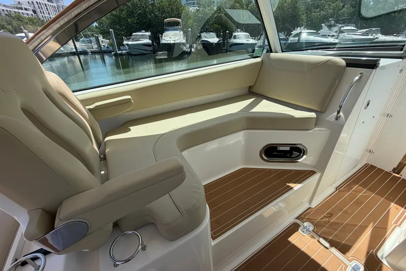 Slide: The Image of 2016 Pursuit DC 325 Dual Console interior with beige seating and wooden flooring. - 41