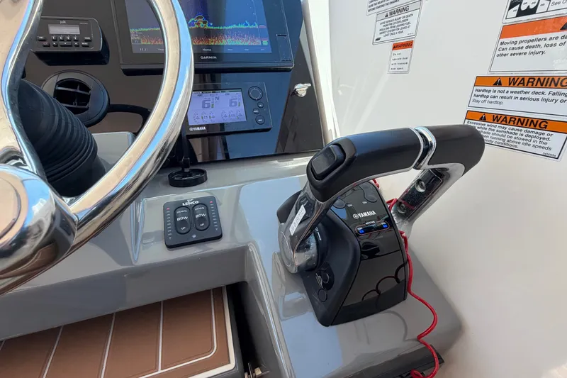 Slide: The Image of Control panel of a 2016 Pursuit DC 325 Dual Console boat with steering wheel and throttle. - 35