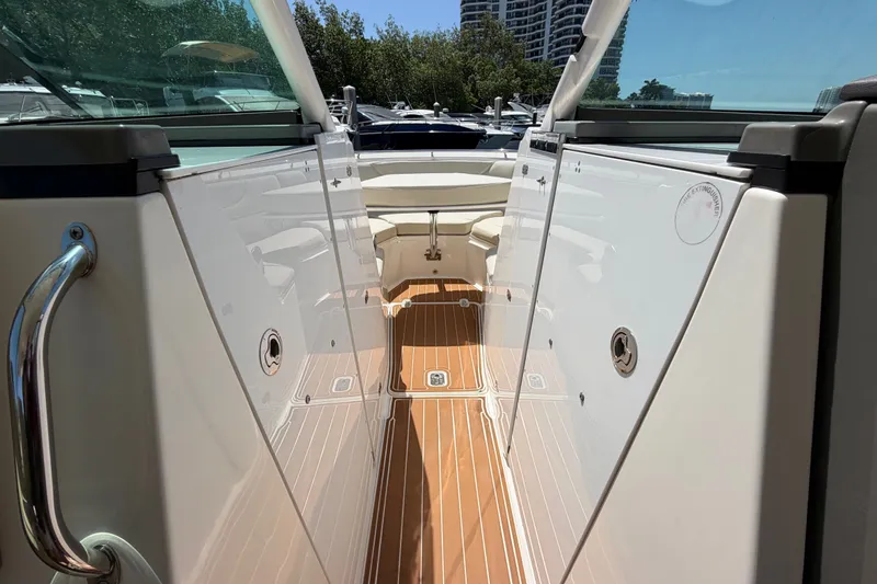 Slide: The Image of 2016 Pursuit DC 325 Dual Console boat interior with sleek design and wooden flooring. - 48