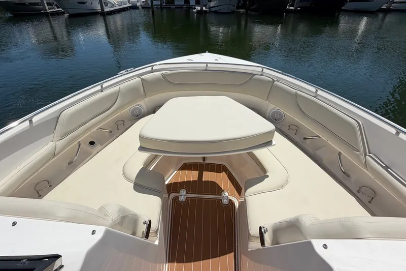 Slide: The Image of 2016 Pursuit DC 325 Dual Console boat interior with cushioned seating and teak flooring. - 49