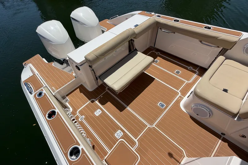 Slide: The Image of 2016 Pursuit DC 325 Dual Console boat with tan seating and twin engines. - 11