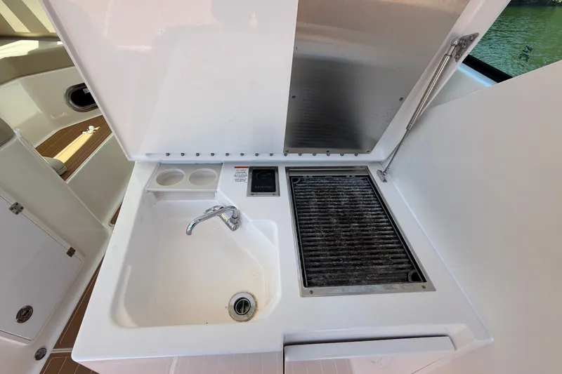 Slide: The Image of 2016 Pursuit DC 325 Dual Console boat sink and grill station. - 22