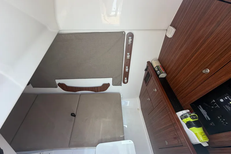 Slide: The Image of Interior cabin of 2016 Pursuit DC 325 Dual Console with wood cabinetry and seating. - 45