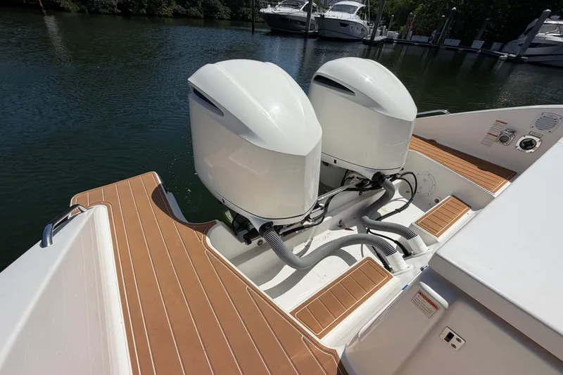 Slide: The Image of 2016 Pursuit DC 325 Dual Console boat with twin outboard engines. - 16