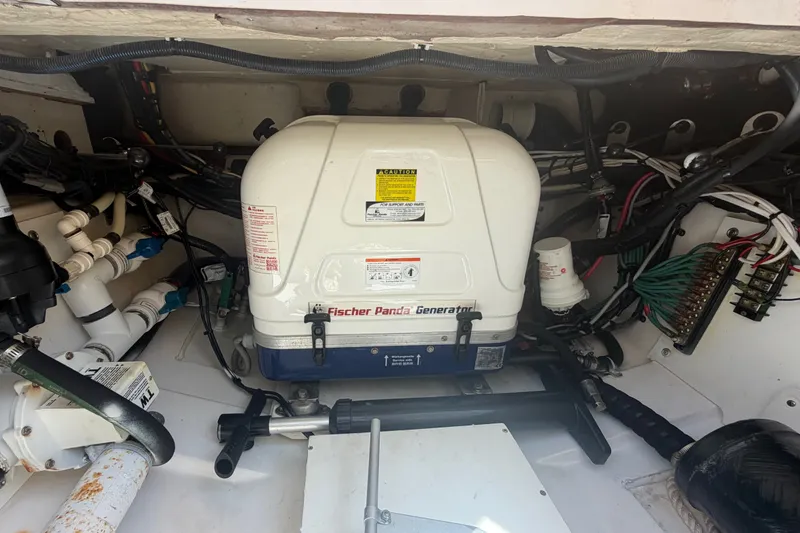 Slide: The Image of Engine compartment of a 2016 Pursuit DC 325 Dual Console with Fischer Panda generator. - 55