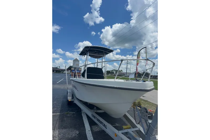 Slide: The Image of 1977 Mako 235 boat on trailer under blue sky with clouds. - 7