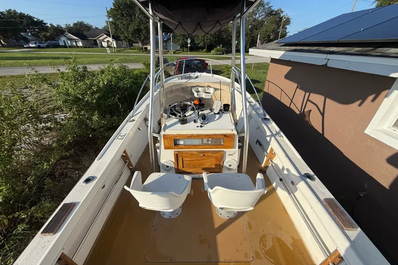 Slide: The Image of 1977 Mako 235 boat interior with dual seats and steering console. - 22