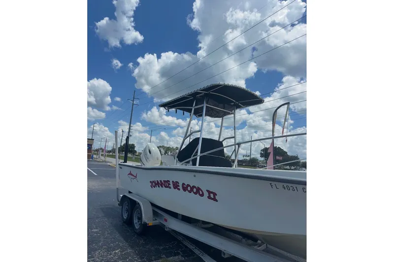 Slide: The Image of 1977 Mako 235 boat on trailer under blue sky with clouds. - 8
