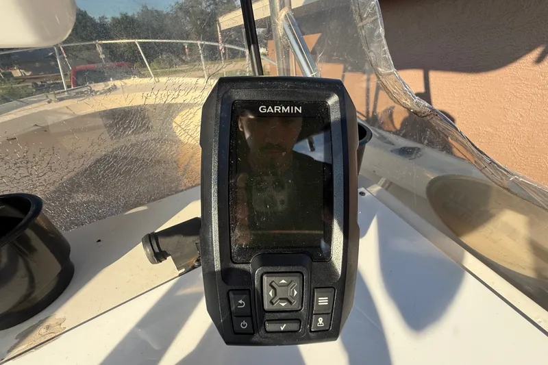 Slide: The Image of Garmin device on 1977 Mako 235 boat dashboard, sunny day, clear view. - 26