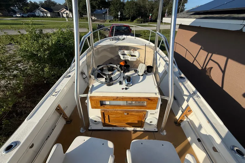 Slide: The Image of 1977 Mako 235 boat interior with steering wheel and control panel. - 23