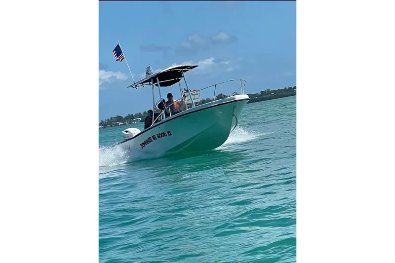 The Image of 1977 Mako 235 boat cruising on clear blue water under a sunny sky. - 0