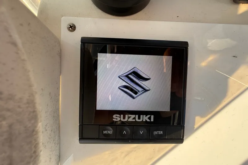 Slide: The Image of Suzuki display screen on a 1977 Mako 235 boat dashboard. - 27