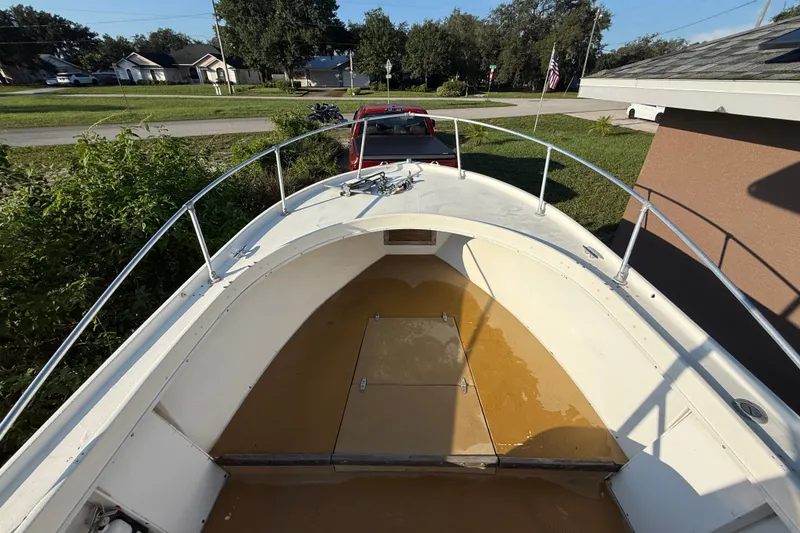 Slide: The Image of 1977 Mako 235 boat deck with railing, parked in a residential area. - 33