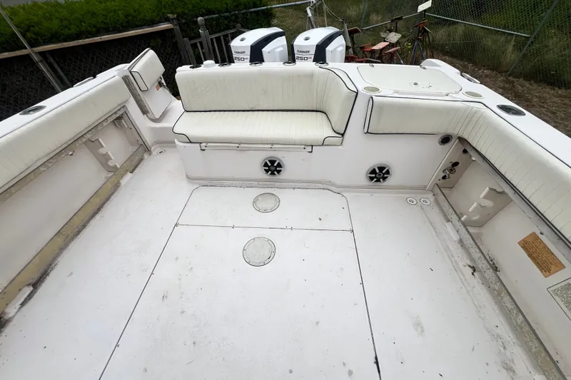 Slide: The Image of 1996 Grady-White Marlin 300 boat interior with seating and dual Evinrude engines. - 21