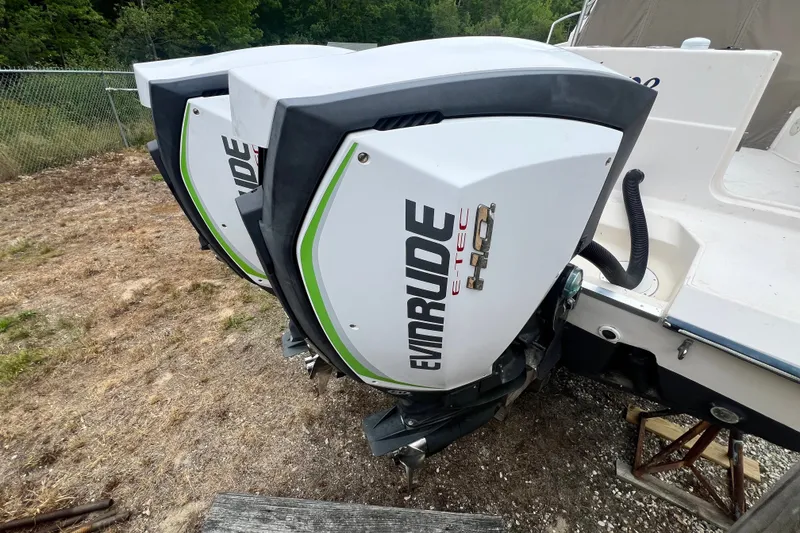 Slide: The Image of Twin Evinrude E-TEC outboard engines on a 1996 Grady-White Marlin 300 boat. - 6