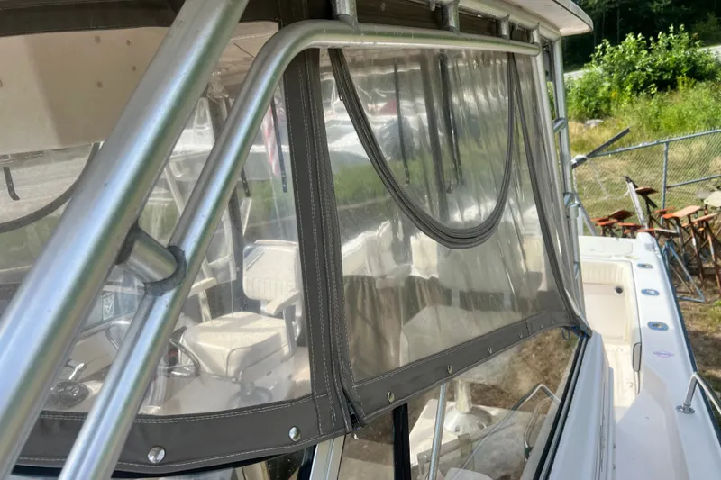 Slide: The Image of 1996 Grady-White Marlin 300 boat with clear enclosure and metal framework. - 33