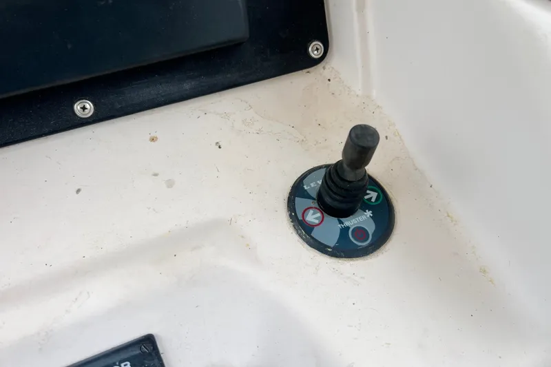 Slide: The Image of Control panel of a 1996 Grady-White Marlin 300 boat, featuring a thruster joystick. - 8