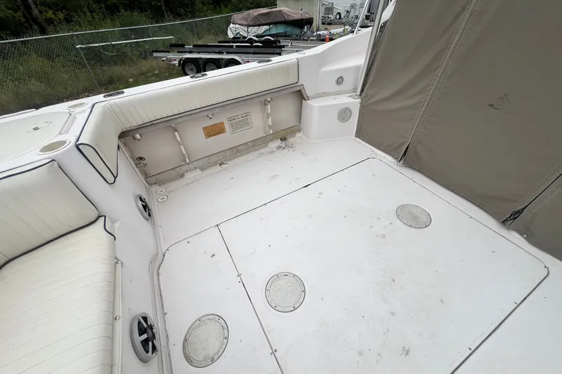 Slide: The Image of 1996 Grady-White Marlin 300 boat interior with white seating and storage compartments. - 20