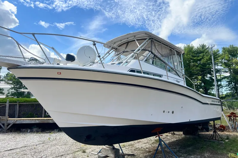 Slide: The Image of 1996 Grady-White Marlin 300 boat on stands, under a clear blue sky. - 2