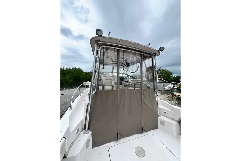 Slide: The Image of 1996 Grady-White Marlin 300 boat with enclosed cockpit, overcast sky background. - 26