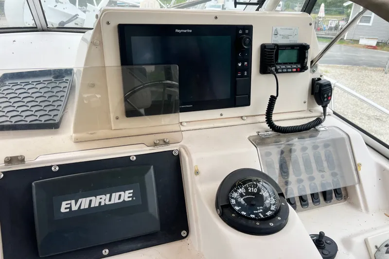 Slide: The Image of 1996 Grady-White Marlin 300 boat dashboard with navigation equipment and Evinrude system. - 7