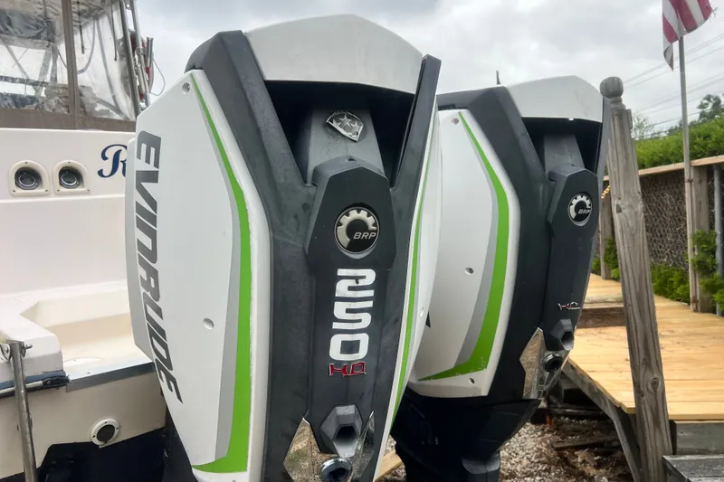 Slide: The Image of Twin Evinrude outboard engines on a 1996 Grady-White Marlin 300 boat. - 29