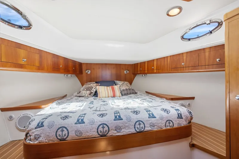 Slide: The Image of Luxurious 2009 Rivolta Coupe 4.5 cabin interior with nautical-themed bedding and wooden accents. - 52