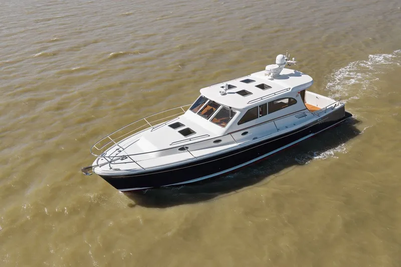 Slide: The Image of 2009 Rivolta Coupe 4.5 yacht cruising on calm waters. - 24