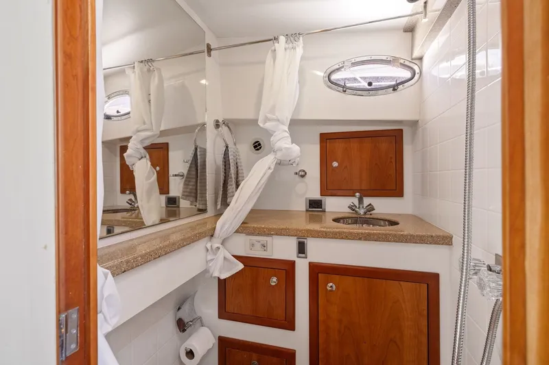 Slide: The Image of Luxurious bathroom in a 2009 Rivolta Coupe 4.5, featuring wood accents and modern fixtures. - 49