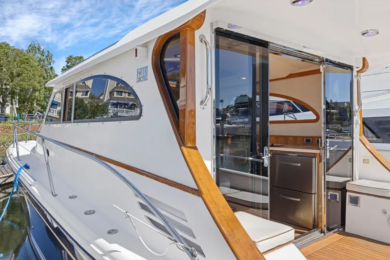 Slide: The Image of 2009 Rivolta Coupe 4.5 yacht with sleek design, docked near waterfront homes. - 29