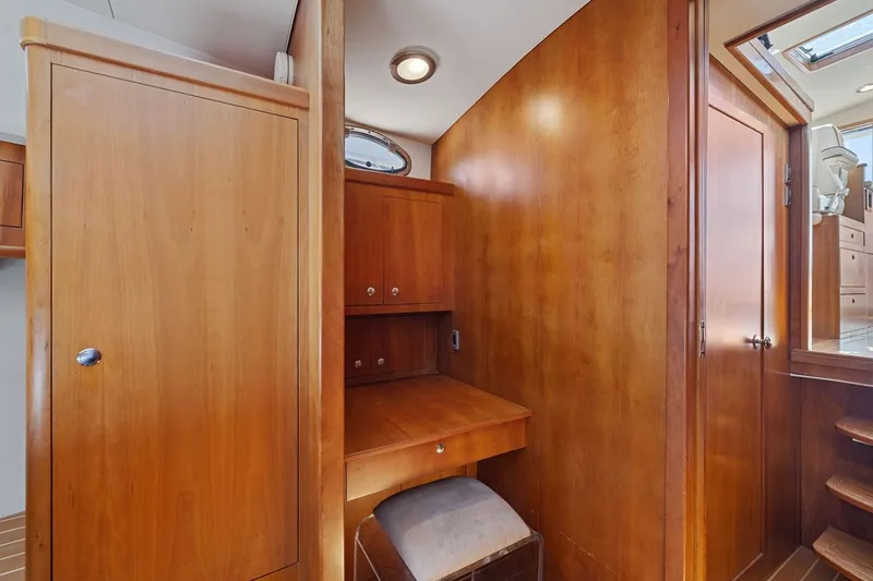 Slide: The Image of Wood-paneled interior of 2009 Rivolta Coupe 4.5, featuring a compact desk and storage. - 53