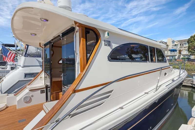 Slide: The Image of 2009 Rivolta Coupe 4.5 yacht docked, showcasing sleek design and luxurious features. - 27