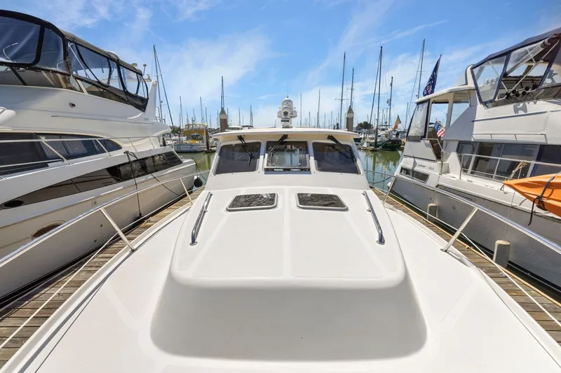 Slide: The Image of 2009 Rivolta Coupe 4.5 yacht docked at marina, surrounded by other boats. - 59