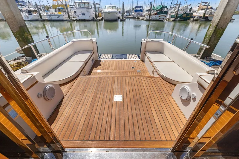 Slide: The Image of Luxurious 2009 Rivolta Coupe 4.5 yacht deck with elegant wood finish and marina view. - 33