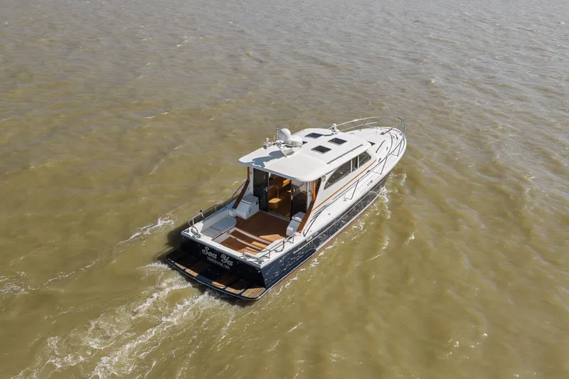 Slide: The Image of 2009 Rivolta Coupe 4.5 yacht cruising on open water, aerial view. - 22