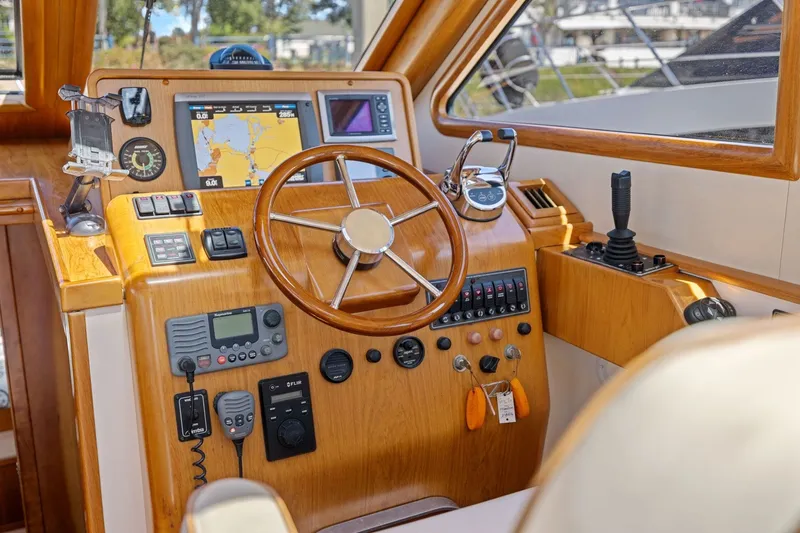 Slide: The Image of Interior of 2009 Rivolta Coupe 4.5 boat with wooden dashboard and navigation equipment. - 40