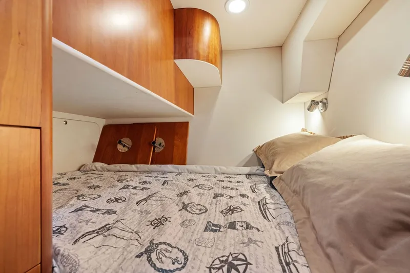 Slide: The Image of Cozy interior cabin of 2009 Rivolta Coupe 4.5 with nautical-themed bedding. - 47