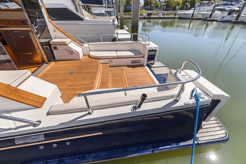 Slide: The Image of Luxurious 2009 Rivolta Coupe 4.5 yacht with elegant wooden deck and seating area. - 31
