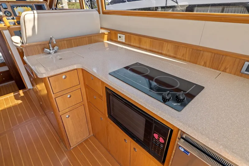 Slide: The Image of Luxurious 2009 Rivolta Coupe 4.5 yacht kitchen with stove, sink, and microwave. - 38