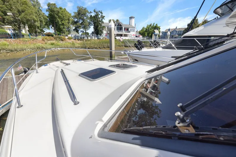 Slide: The Image of 2009 Rivolta Coupe 4.5 yacht docked at marina, surrounded by trees and buildings. - 61