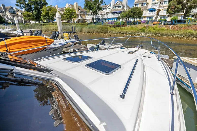 Slide: The Image of 2009 Rivolta Coupe 4.5 yacht docked at marina with waterfront homes in background. - 56