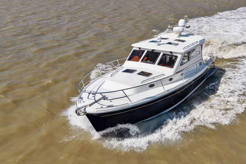 Slide: The Image of 2009 Rivolta Coupe 4.5 boat cruising on open water. - 26