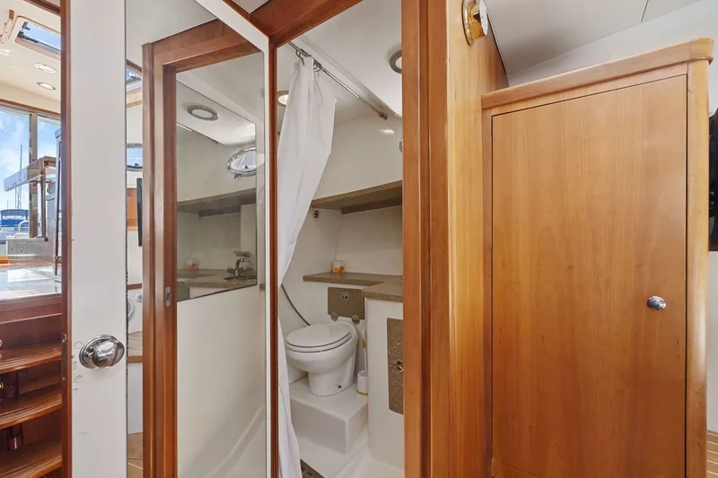 Slide: The Image of Luxurious 2009 Rivolta Coupe 4.5 yacht bathroom with wooden cabinetry and modern fixtures. - 54