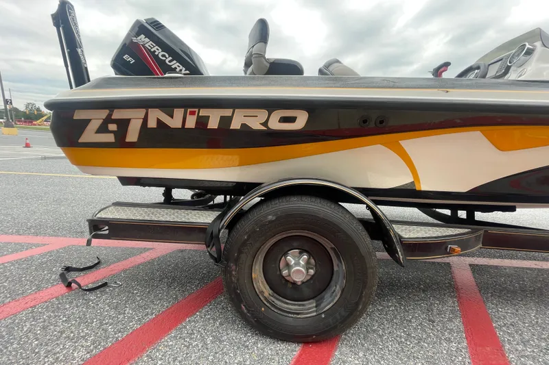Slide: The Image of 2008 Nitro Z-7 boat on trailer with Mercury engine, parked on asphalt. - 15