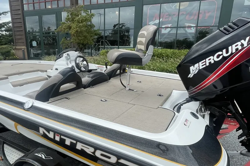Slide: The Image of 2008 Nitro Z-7 boat with Mercury engine, parked outside a building. - 3