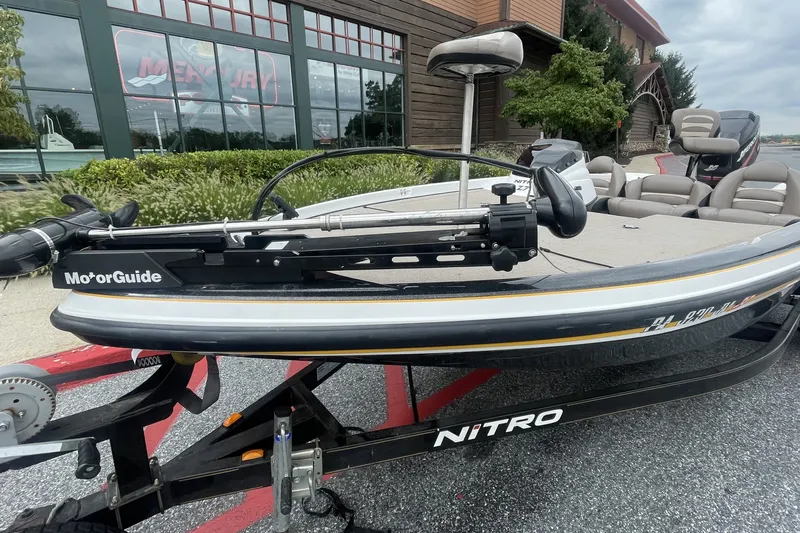 Slide: The Image of 2008 Nitro Z-7 boat with MotorGuide, parked on a trailer outside a building. - 2