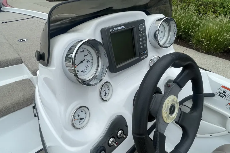 Slide: The Image of Dashboard of a 2008 Nitro Z-7 boat with gauges and steering wheel. - 12