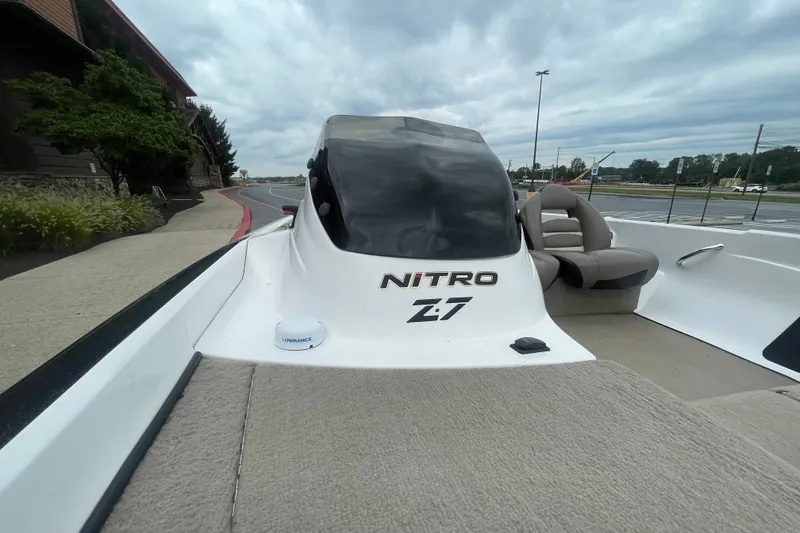 Slide: The Image of 2008 Nitro Z-7 boat with Lowrance equipment, parked on a paved area under cloudy skies. - 9